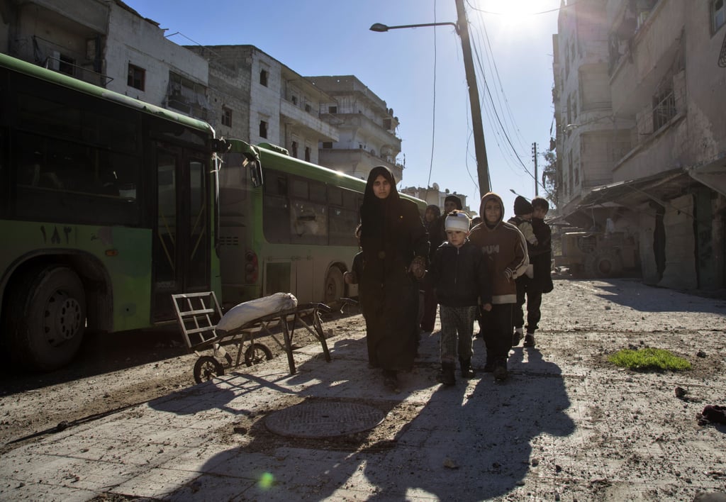 Syrians Walk Through Aleppo During The Evacuation Operation Of Rebels Photos From Aleppo 9591