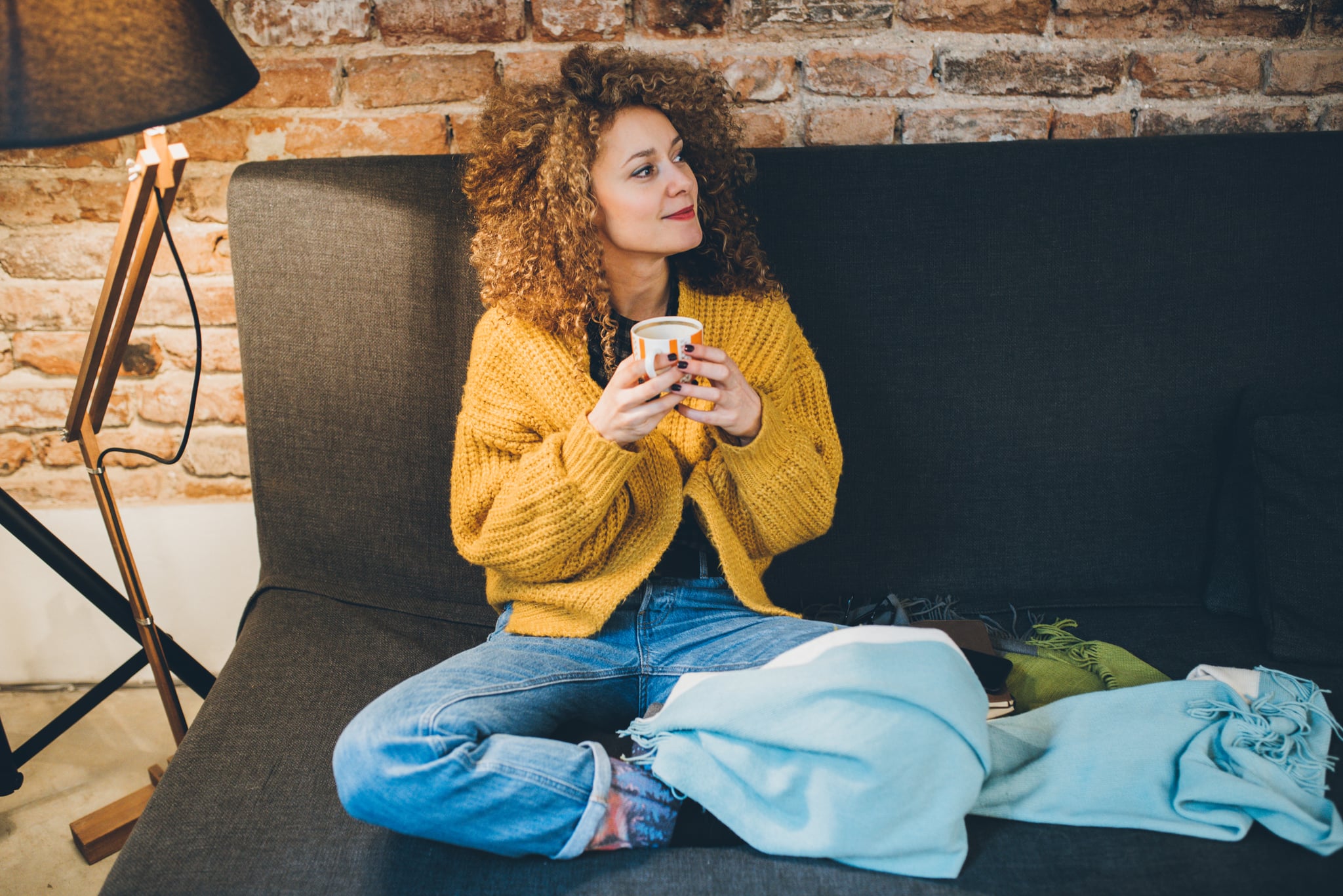 Woman drinking some coffee on the sofa