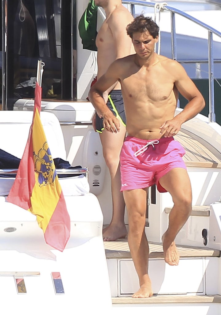 Rafael Nadal may have lost his Wimbledon match against Canadian Milos Raonic last week, but it looks like he still has plenty to smile about. The athlete traded his tennis whites for a bright pink bathing suit while vacationing in Ibiza with friends on Tuesday — check out more sports stars showing skin in the sun. Rafael's early exit from Wimbledon made time for his getaway, but before he headed to Spain, he shared a sweet message with his fans on Facebook: "We're leaving Wimbledon. I want to thank your incredible support, both when things work out and when they don't." It's not the first time he's escaped to his home country after the famed tennis tournament; he traveled to Formentera after his Wimbledon loss in 2011 and to Mallorca following his victory over Roger Federer in 2008. 
Rafael will have another chance at winning big on July 16, since he's up for the best international athlete prize at the ESPYs, which will be hosted by Drake.