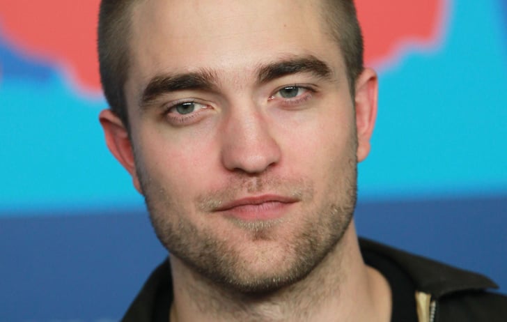 Handsome Rob gave a little smile for the cameras at the