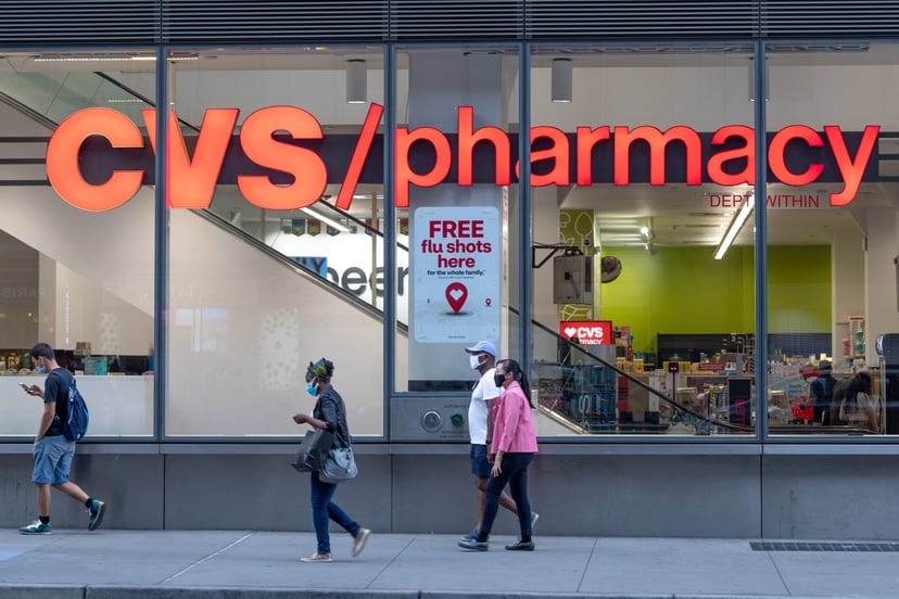 NEW YORK, NEW YORK - AUGUST 26: People wearing masks walks past a CVS Pharmacy where a