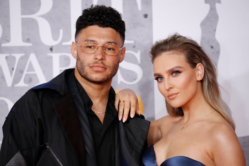 British footballer Alex Oxlade-Chamberlain and girlfriend Perrie Edwards (R) pose on the red carpet on arrival for the BRIT Awards 2019 in London on February 20, 2019. (Photo by Tolga AKMEN / AFP) / RESTRICTED TO EDITORIAL USE  NO POSTERS  NO MERCHANDISE 