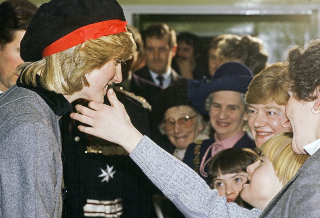 A young boy sweetly touched Diana's face as she visited Liverpool in December 1982.