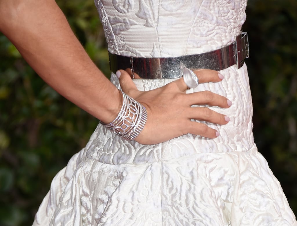 Salma Hayek added metallic contrasts against her white McQueen gown.