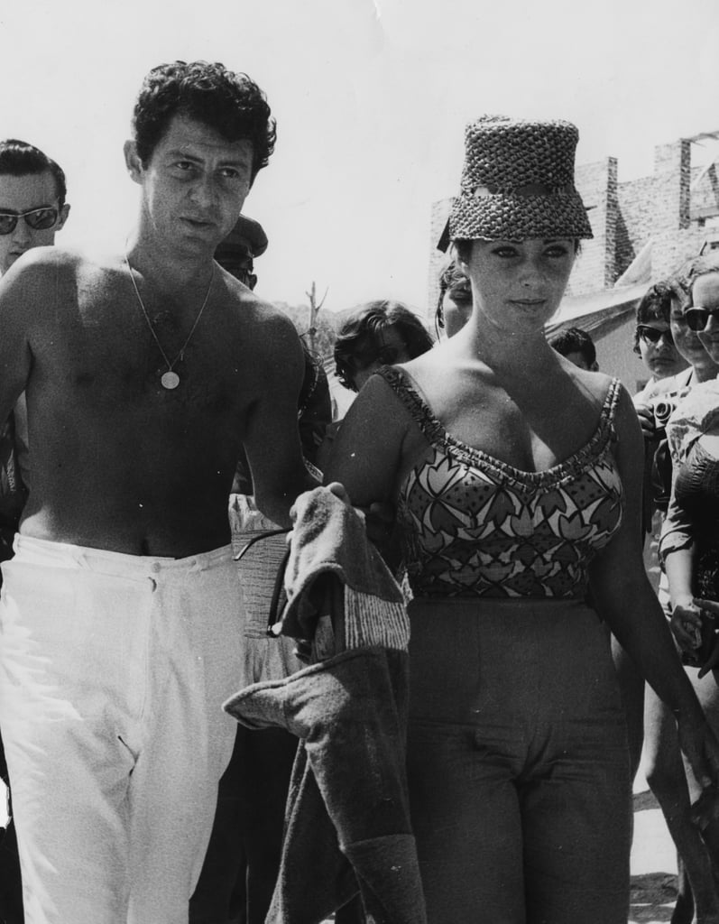 In 1960, Liz covered her face from the sun in this chic woven hat.