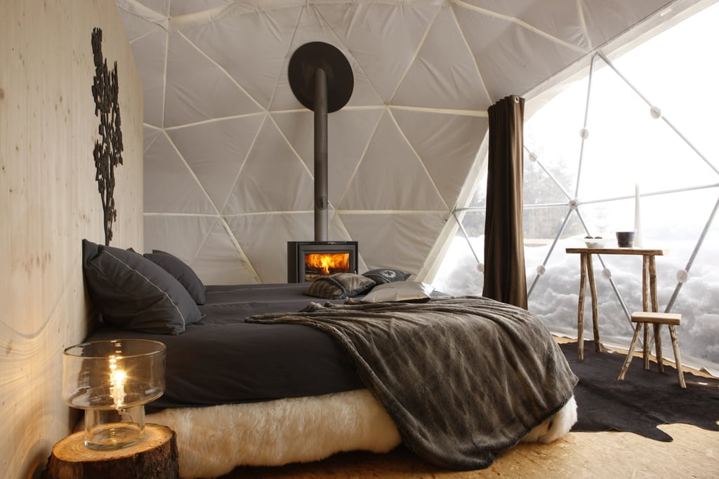 A view of the outdoors, a warm fireplace, and earthen elements make this bedroom a perfect fit for Pocahontas.