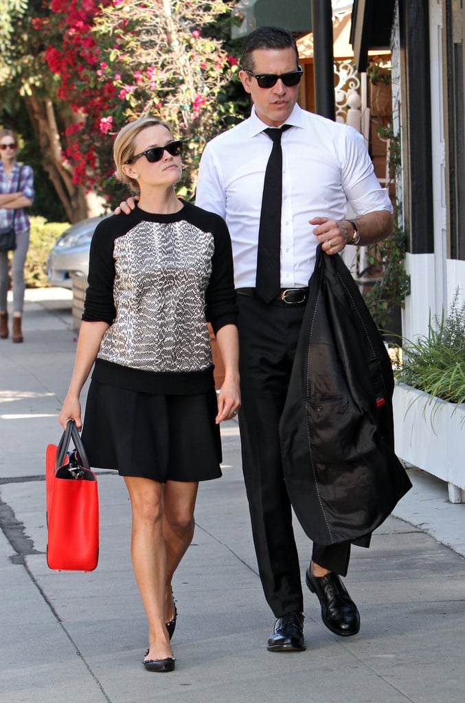 For an LA afternoon, Reese topped a black swing skirt with a snakeskin Jason Wu sweatshirt and studded Valentino flats, then added a splash of color via a crimson Jason Wu tote.