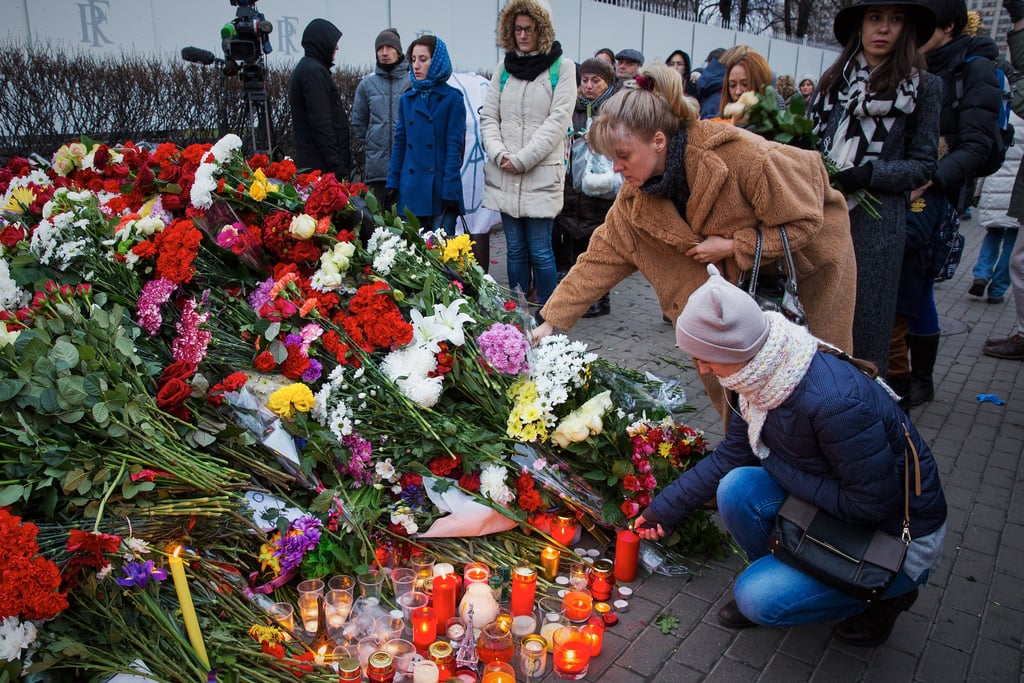 People laid flowers near the French embassy in Moscow.