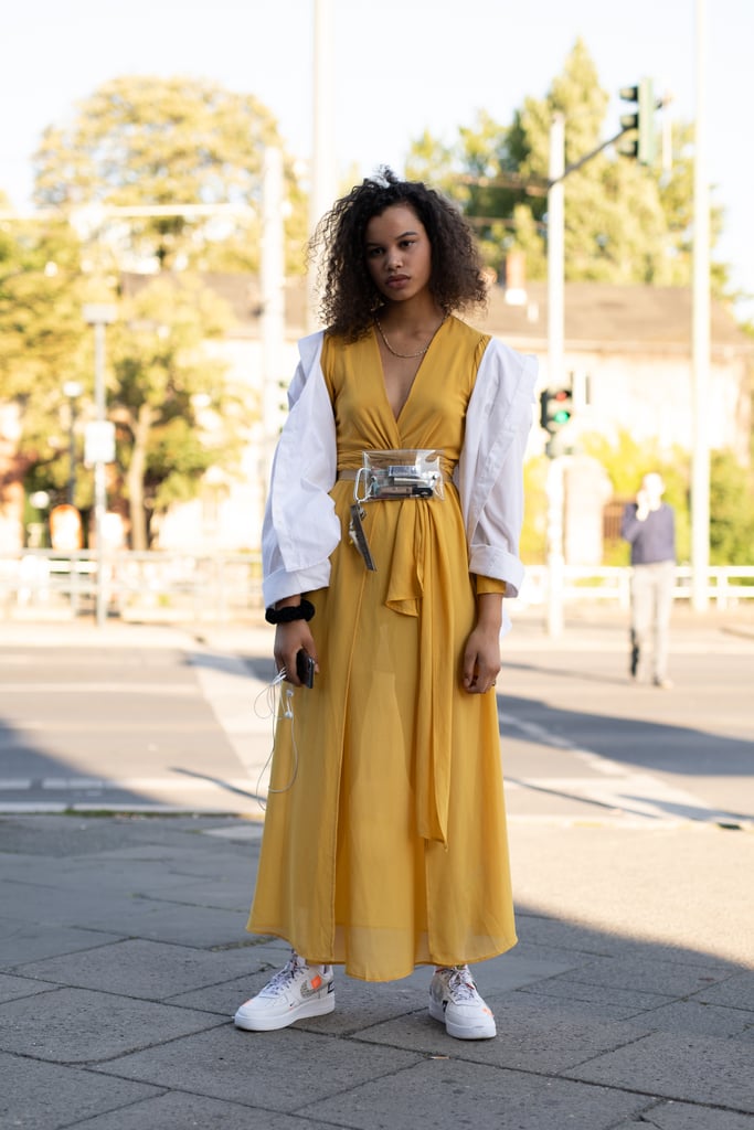 White sneakers are a fresh way to finish off a vibrant maxi dress.