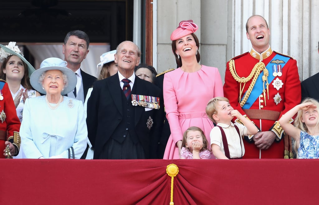 London spared the city from its usual rain for a lovely Trooping the Colour celebration last year. The annual parade — which was held in honor of Queen Elizabeth II's 91st birthday — featured some pretty cute moments from the royal family as they watched from a balcony at Buckingham Palace above the festivities. Along with the queen and her husband, Prince Philip, Prince William and Kate Middleton brought out their adorable kids, Prince George and Princess Charlotte, to enjoy the morning. 
Princess Charlotte made her balcony debut in 2016, and her second appearance did not disappoint. Dressed in the same shade of pink as her mom, she soaked it all in with some pretty hilarious facial expressions, which she no doubt picked up from her older brother. George (who was dressed in a supercute suspender outfit, naturally) continued his tradition of "over it" looks, but couldn't help but get excited when jets from the Royal Air Force roared by overhead. The littlest royals and their parents were also joined by Prince Harry, Duchess Camilla, Prince Charles, Prince Andrew, Prince Edward, Princess Beatrice, and Princess Eugenie. 
Trooping the Colour is always one of the royal family's most spectacular events of the year. Although the queen's birthday is actually on April 21, the event is typically scheduled in June since there's a better chance the weather will be nice. Kate and Camilla rode in a carriage together with Prince Harry, while Queen Elizabeth II and Prince Philip waved to the crowd from their own. They were accompanied by more than 1,400 officers and 200 horses (one of which was ridden by Prince William!) as their carriages made their way from Buckingham Palace across St. James's Park. 
After the tragedies London has endured over the last few months, hopefully the day brought a smile to more than a few faces.