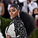 Simone Biles Wears White Criss-Cross Top & High-Waist Pants