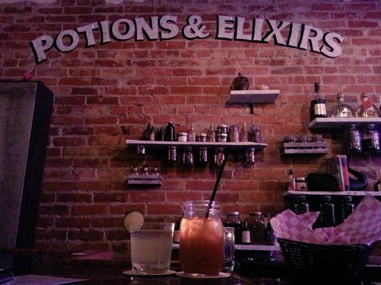 "Potions & elixirs" is painted on a brick wall — but do they have amortentia?