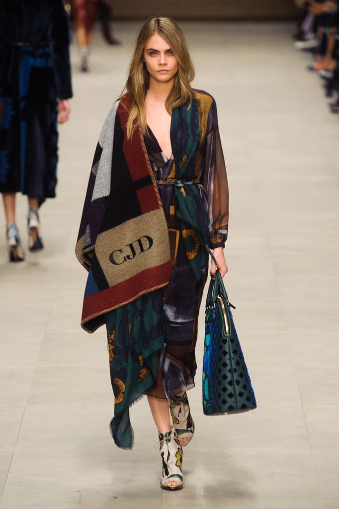 To be fair, Cara Delevingne had her monogrammed poncho first when she walked the Burberry Fall '14 runway.