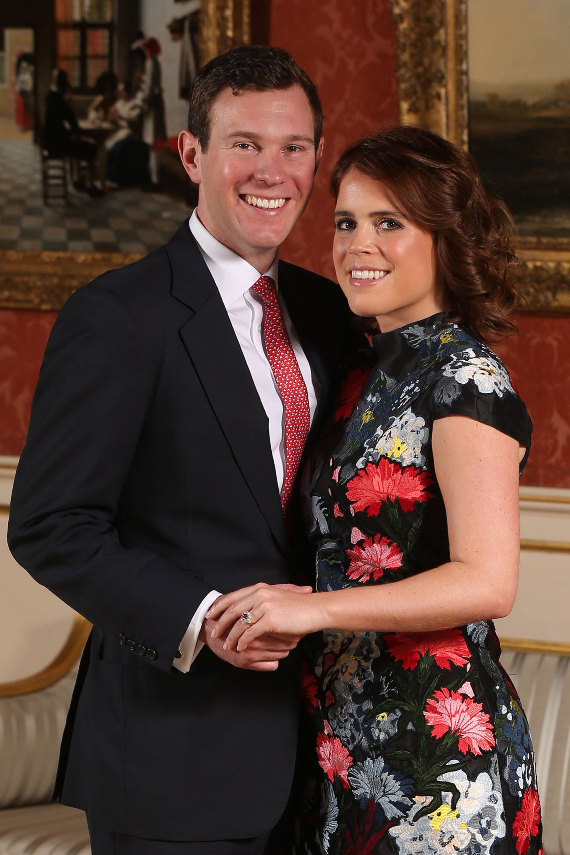 LONDON, ENGLAND -JANUARY 22: (EDITOR'S NOTE: Alternative crop of image #908732602) Princess Eugenie and Jack Brooksbank pose in the Picture Gallery at Buckingham Palace after they announced their engagement. Princess Eugenie wears a dress by Erdem, shoes by Jimmy Choo and a ring containing a padparadscha sapphire surrounded by diamonds on January 22, 2018 in London, England..  They are to marry at St George's Chapel in Windsor Castle in the autumn this year. (Photo by Jonathan Brady - WPA Pool/Getty Images)