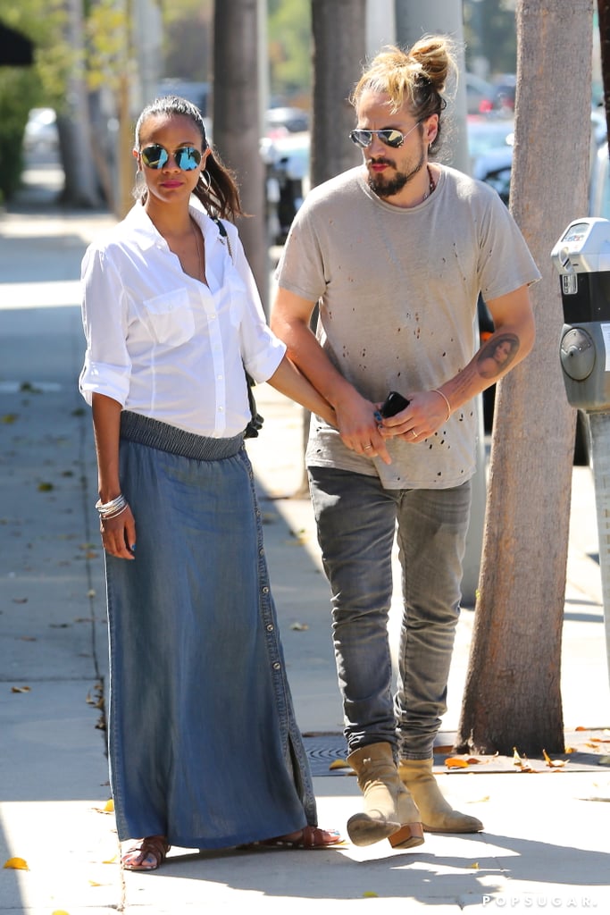 Zoe Saldana hid her baby bump during her Thursday afternoon with husband Marco Perego in LA.