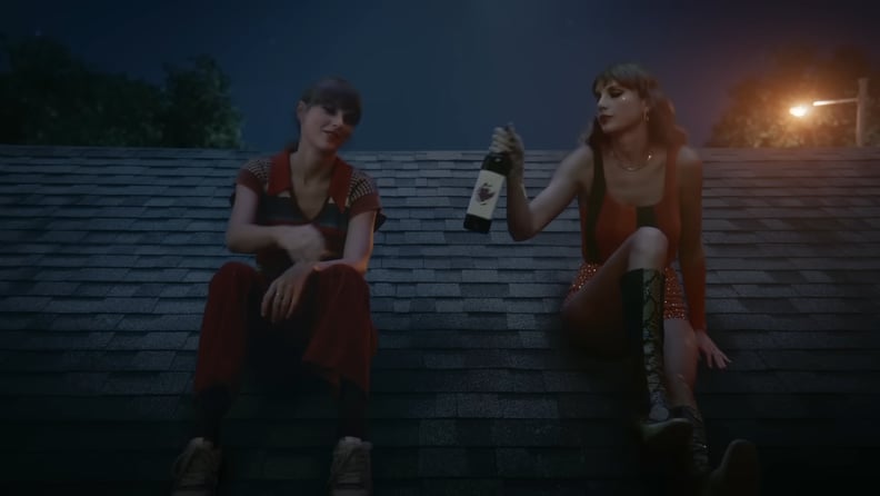 Two Taylor Swifts sitting on the roof in "Anti-Hero"