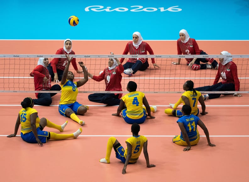 Rwanda (front) plays Iran in a Sitting Volleyball Women's Preliminaries Pool B Match for the Paralympic Games, in Rio de Janeiro, Brazil, on September 12, 2016. Photo By Simon Bruty or OIS/IOC via AFP.  RESTRICTED TO EDITORIAL USE.    / AFP / OIS/IOC / Si