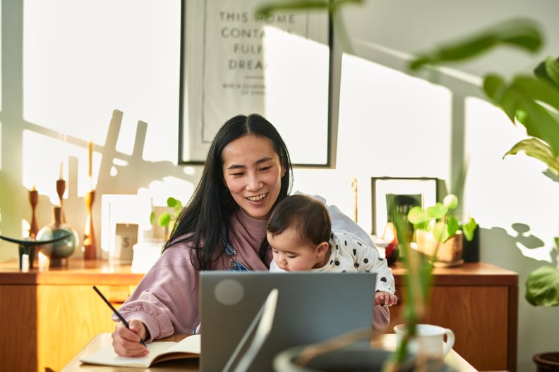 Mom working at her desk while holding her baby