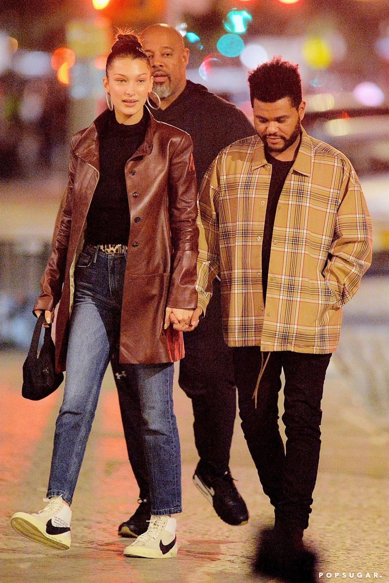 Bella Hadid looks stylish in a brown suede vest, brown leather pants and  snakeskin boots as