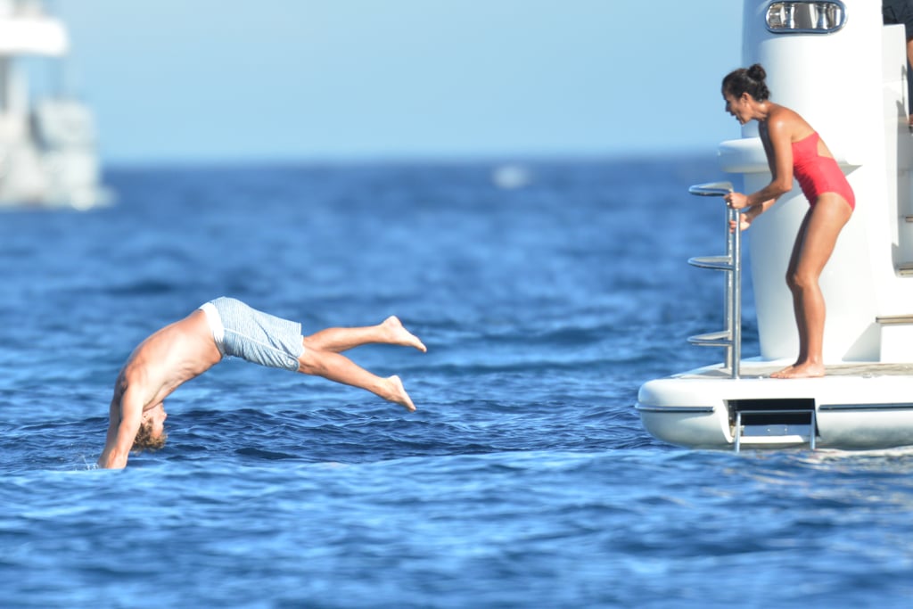 On Friday, Simon Baker dove off a yacht in Saint-Tropez, France, as wife Rebecca Rigg looked on.