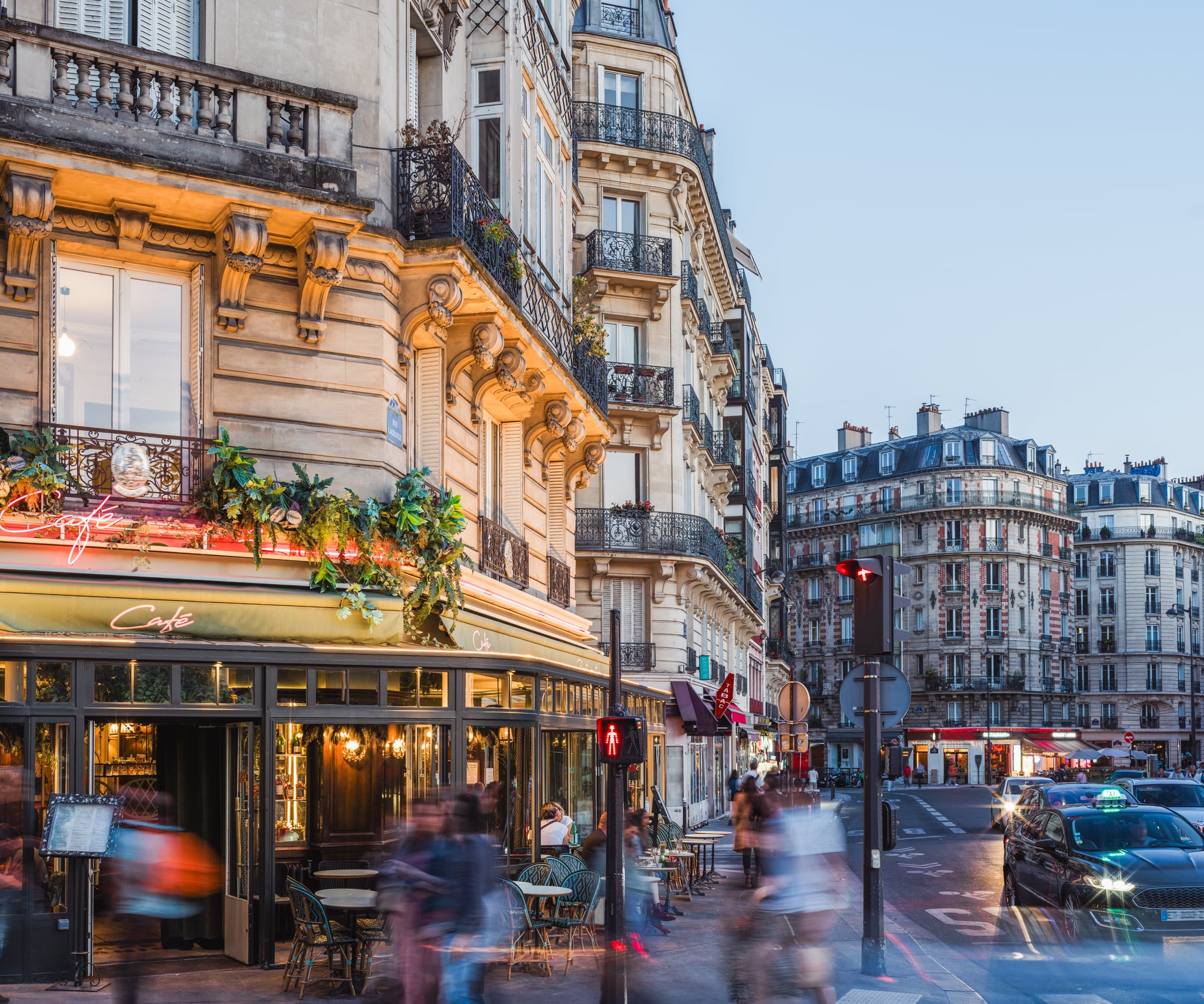 A Parisian street is shown at dusk.