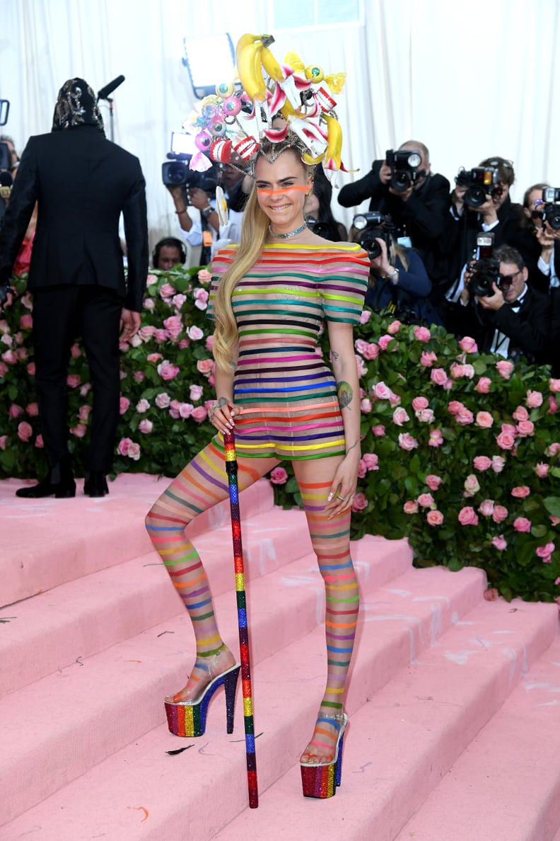 So Camp: Cara Delevingne in Pride Platforms With a Headpiece Made of "Body Parts"