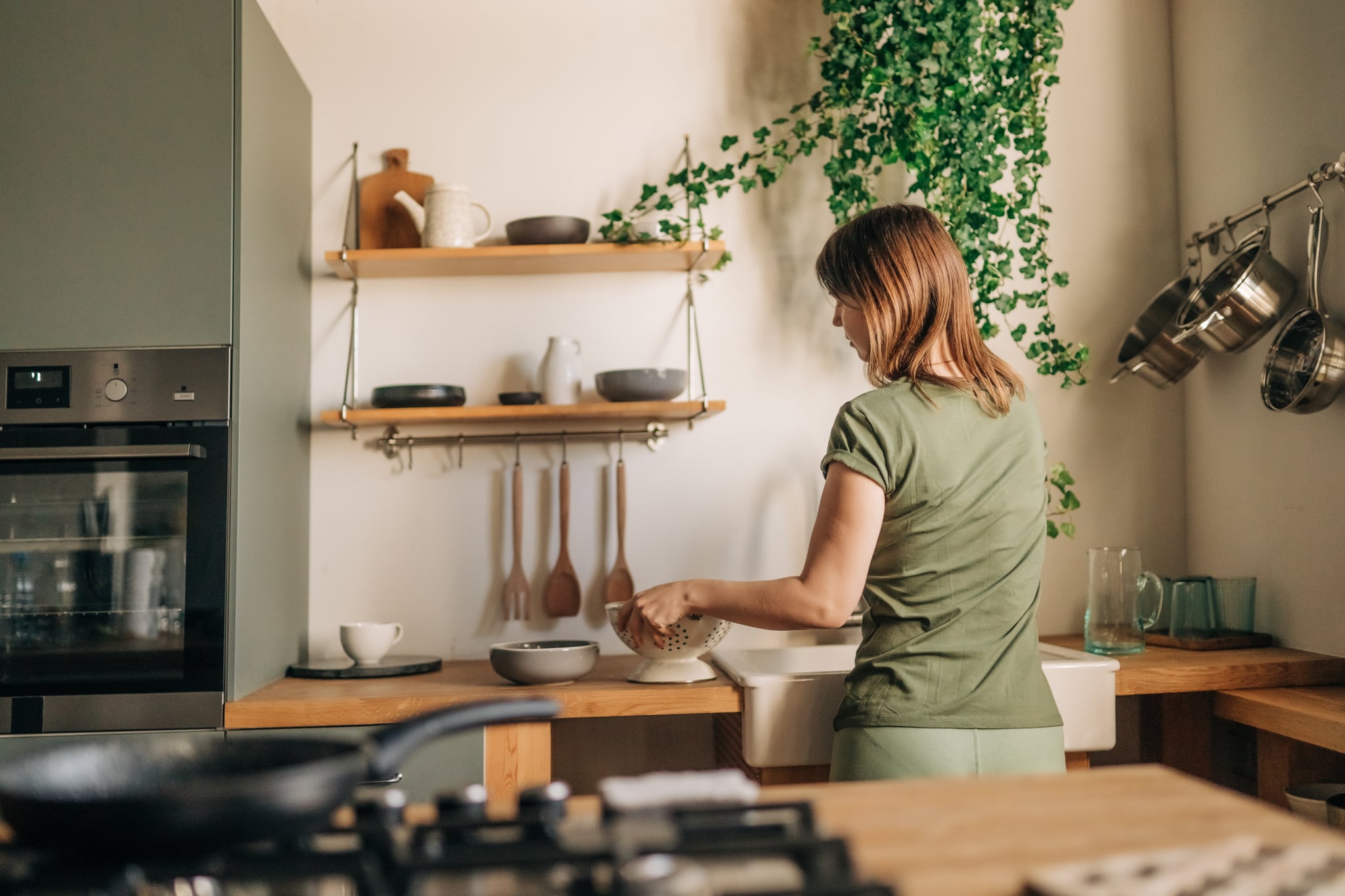 A woman doing the dishes after dinner.