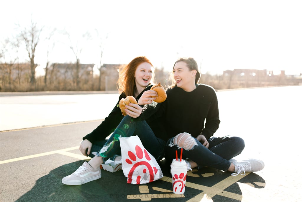 Caitlyn Stepp and her best friend, Abby, knew they wanted to commemorate their high school years in a big way: by paying tribute to their favorite restaurant, Chick-fil-A, with a custom photo shoot. And who better to enlist than Caitlyn's older sister, photographer Courtney Stepp, to do the honors? Courtney told POPSUGAR that she was happy to take the pictures since the pair have been virtually inseparable since they met in the eighth grade. 
"These two have always been so close that I feel like Abby is a sister to me. From dinners to hikes, there is no hiding that they are the best of friends," she said. "They're always goofing off and cracking jokes, pranking one another, or gossiping about the boys they like. I've witnessed their friendship this entire time, so by their senior year I knew I had to make something unique but also really fun."
The girls picked up some of their most beloved menu items from the nearest Chick-fil-A and headed to a park that they both clocked many hours in during their childhoods. And we have to say, the results are pretty fantastic. Scroll through to see some of the best shots before stealing the idea for yourself. 

    Related:

            
            
                                    
                            

            To Celebrate Decades of Marriage, This Couple Had an Entire Photo Shoot at Taco Bell