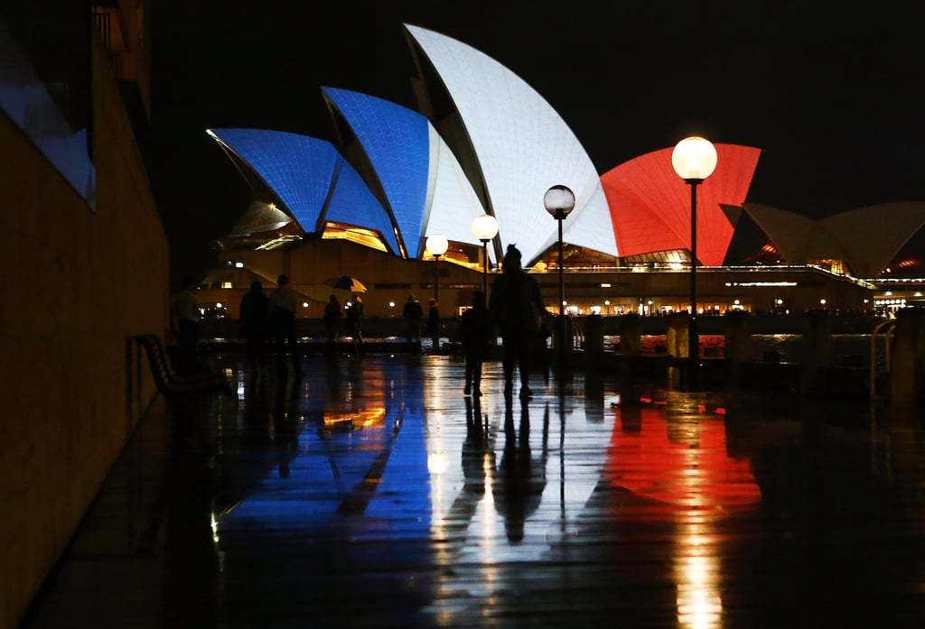 The Sydney Opera House lit up in the colors of France's flag.