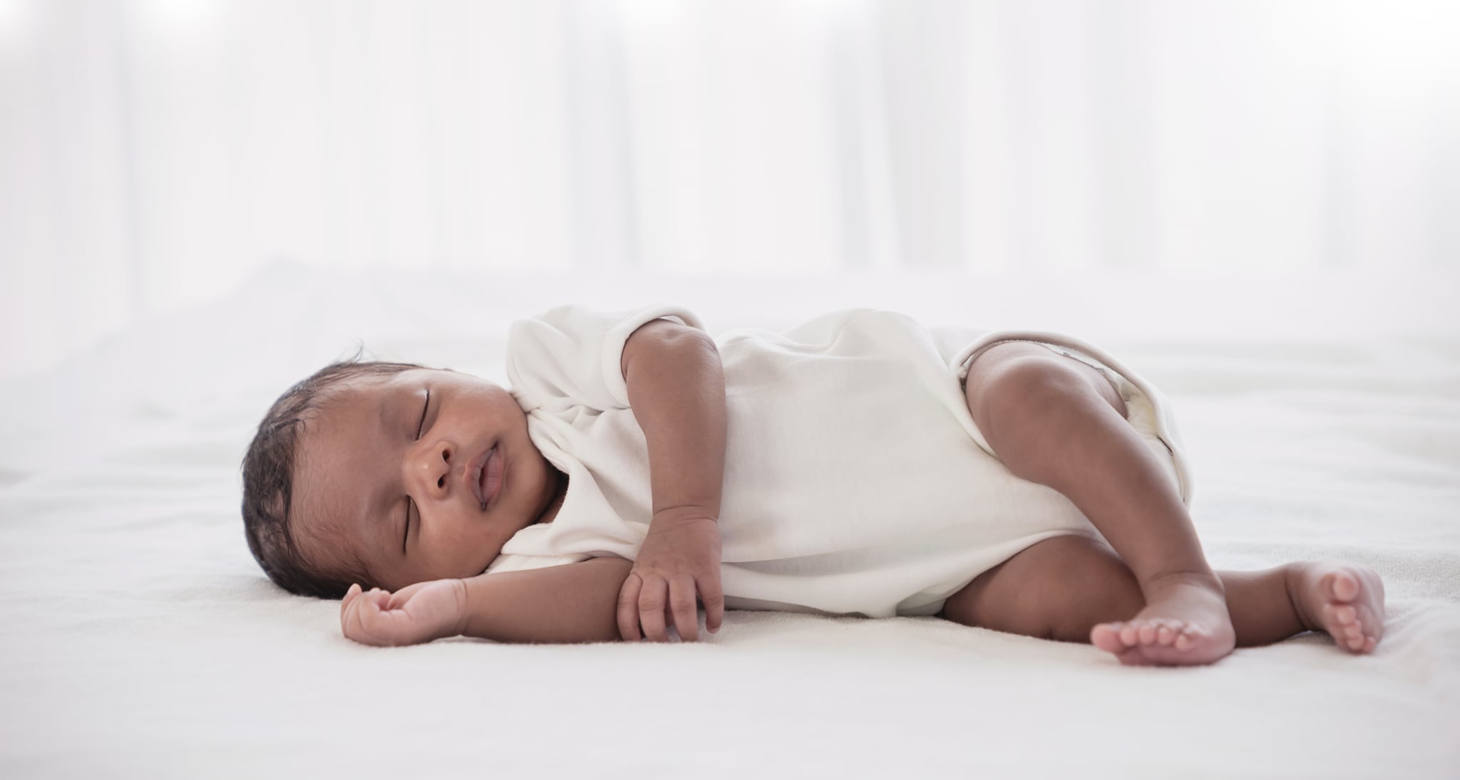 Portrait of African American  newborn baby body sleeping in bed. Closeup new born baby. Love family healthcare and medical body part nursery together happy motherâs day concept