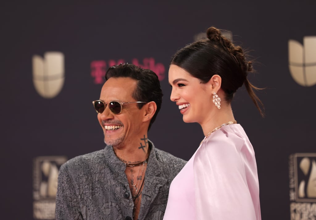 Marc Anthony and Nadia Ferreira brought a special plus one to the Premio Lo Nuestro. Ferreira displayed her baby bump in an ethereal lavender own at the award show on Feb. 23, with Anthony cradling the bump along the red carpet. Later in the night, when Anthony won the award for best tropical album, the singer kissed Ferreira's baby bump before making his way to the stage. "Baby Is Happy Too!" Anthony later wrote on Instagram, posting a picture of Ferreira holding the award to her stomach.
The celebratory evening was the couple's first public appearance since announcing their pregnancy in February, following their wedding in January. "Best Valentine's Gift Ever!!!" Ferreira captioned a photo of Anthony with his hand on her growing belly. "Thank you God for this big blessing in our lives." 
Anthony was first connected to Ferreira, a 23-year-old model and former Miss Universe Paraguay, back in March of 2022, when they were seen together in Mexico City. Anthony seemingly confirmed their romance shortly afterwards via an intimate Instagram photo captioned, "May God multiply everything you wish for us." The two announced their engagement in May 2022, and by the beginning of 2023, they had officially tied the knot at the Pérez Art Museum in Miami. 
This is Ferreira's first marriage, but Anthony's fourth, having previous relationships with Miss Universe winner Dayanara Torres, Jennifer Lopez (with whom he shares 15-year-old twins Emme and Max), and more recently, Shannon De Lima. 

    Related:

            
            
                                    
                            

            Kendall Jenner and Bad Bunny Share a Cozy Embrace Amid Rampant Dating Rumors