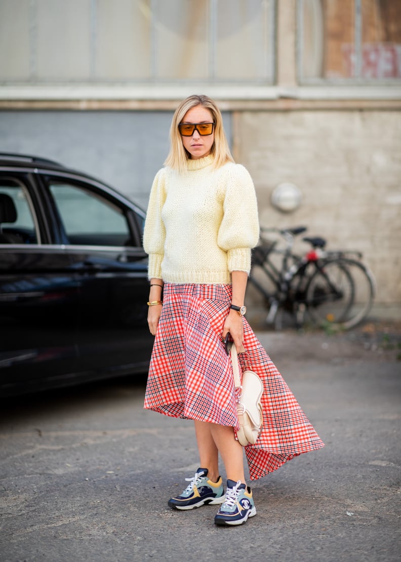 Rework the plaid skirt from schoolgirl to fashion girl with dad sneakers.