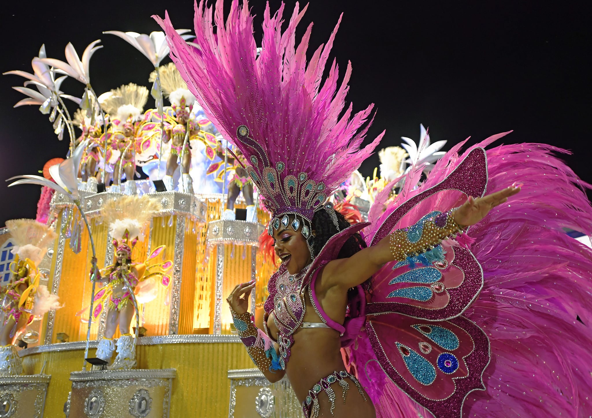 Premium Photo  Three woman in brazilian samba carnival costume with  colorful feathers plumage