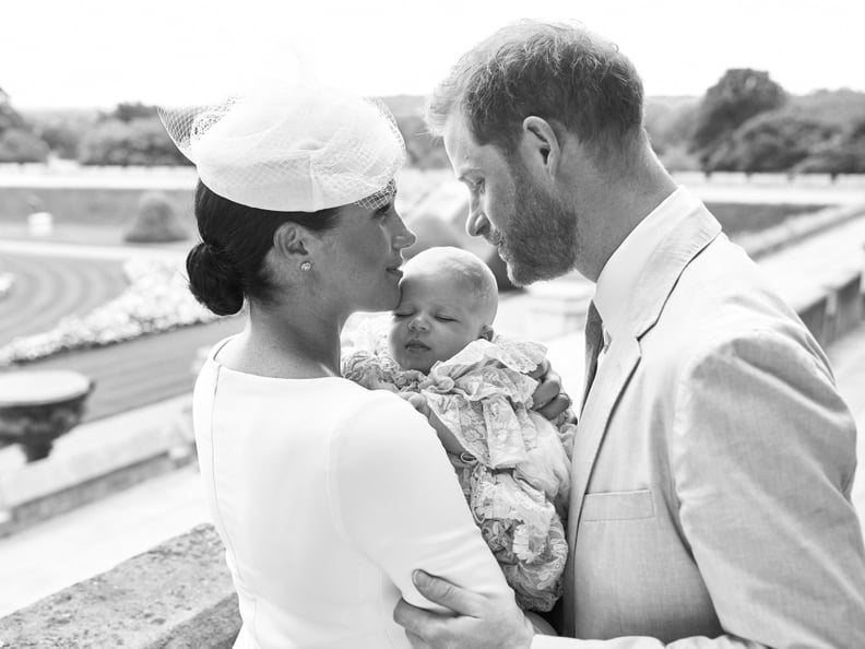 This official handout Christening photograph released by the Duke and Duchess of Sussex shows Britain's Prince Harry, Duke of Sussex (R), and his wife Meghan, Duchess of Sussex holding their baby son, Archie Harrison Mountbatten-Windsor at Windsor Castle 