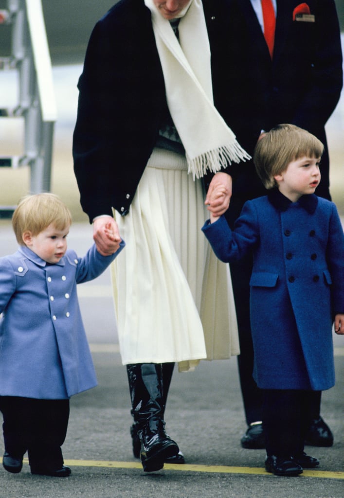 Aww! Harry and William sported matching blue coats as they held hands with their mother while arriving in Scotland back in March 1986.