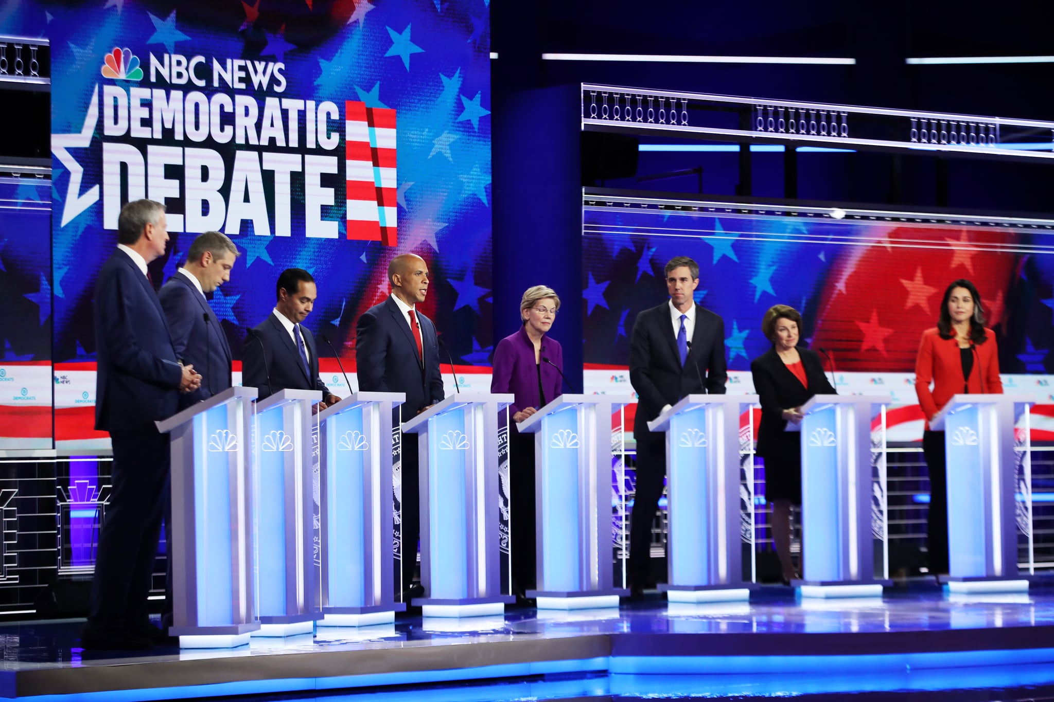 MIAMI, FLORIDA - JUNE 26: Democratic presidential candidates New York City Mayor Bill De Blasio (L-R), Rep. Tim Ryan (D-OH), former housing secretary Julian Castro, Sen. Cory Booker (D-NJ), Sen. Elizabeth Warren (D-MA), former Texas congressman Beto O'Rourke, Sen. Amy Klobuchar (D-MN) and Rep. Tulsi Gabbard (D-HI) take part in the first night of the Democratic presidential debate on June 26, 2019 in Miami, Florida.  A field of 20 Democratic presidential candidates was split into two groups of 10 for the first debate of the 2020 election, taking place over two nights at Knight Concert Hall of the Adrienne Arsht Centre for the Performing Arts of Miami-Dade County, hosted by NBC News, MSNBC, and Telemundo. (Photo by Joe Raedle/Getty Images)