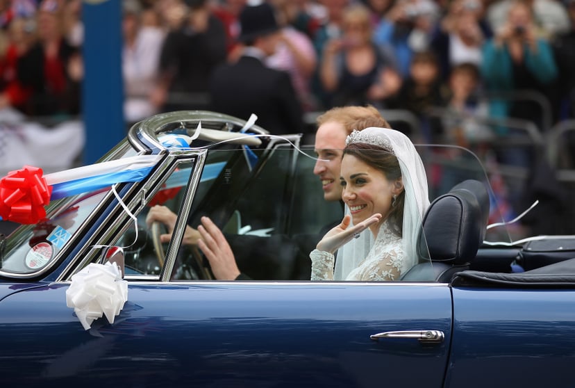 LONDON, ENGLAND - APRIL 29:  Prince William, Duke of Cambridge and Catherine, Duchess of Cambridge drive from Buckingham Palace in a decorated sports car on April 29, 2011 in London, England. The marriage of the second in line to the British throne was le