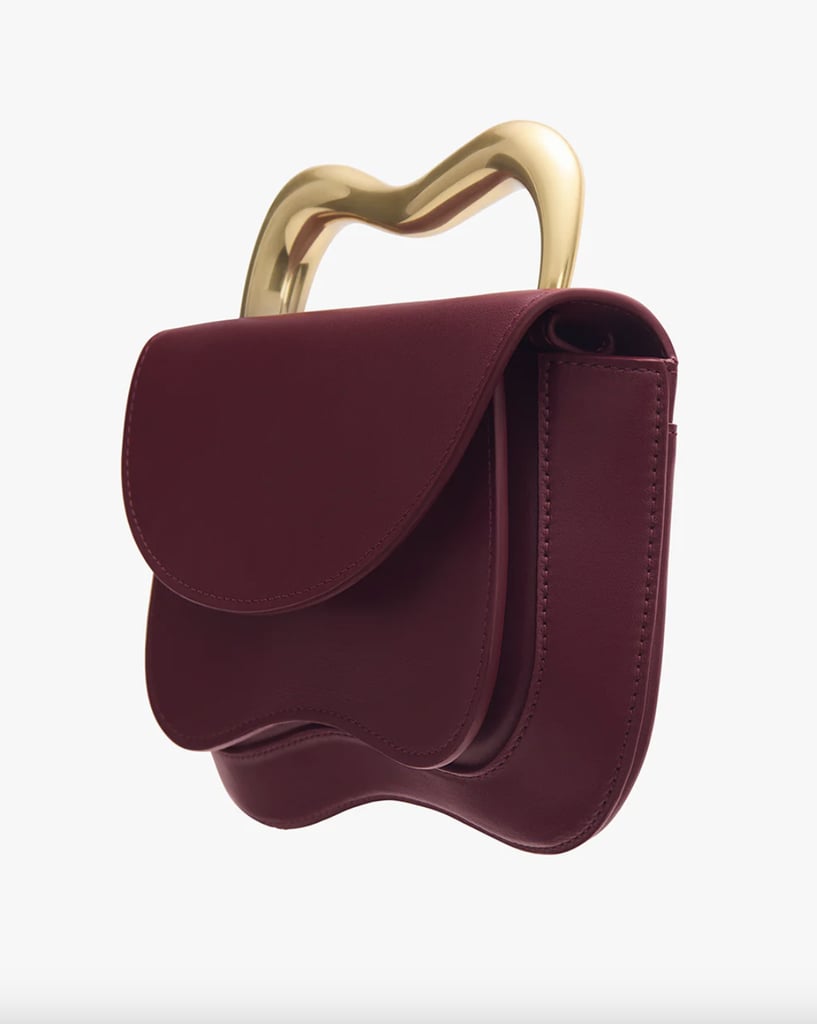 Cuyana Ola Bag ($498)
While it's a bit pricier than some of the other items on this list, this Cuyana bag feels like the epitome of luxury — with a merlot coloring, asymmetrical design, and functional gold handle that's equally practical and stylish.