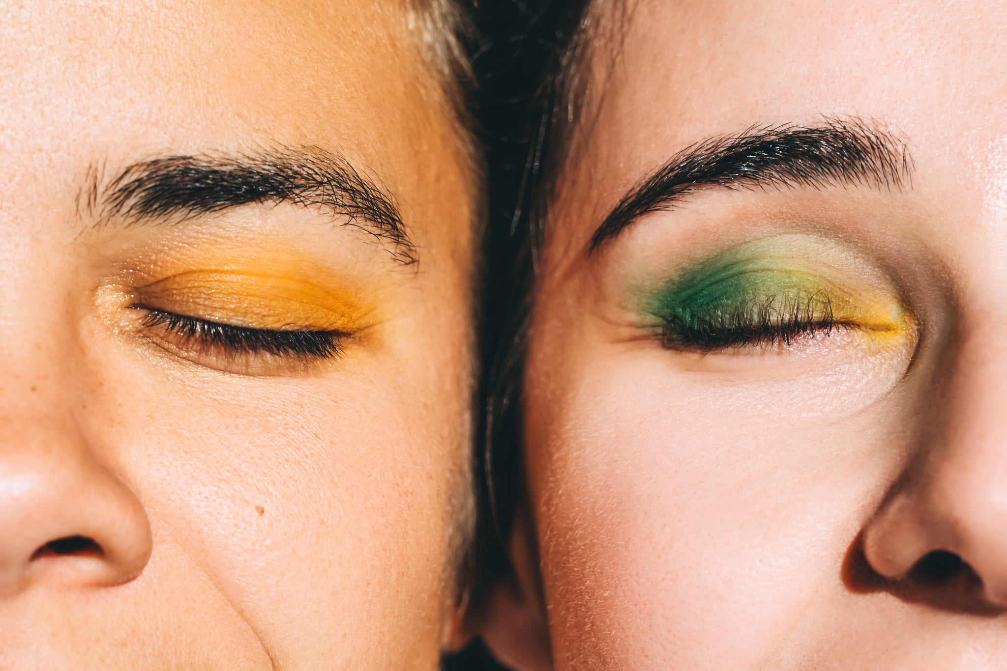 close-up shot of two women with bright eye makeup