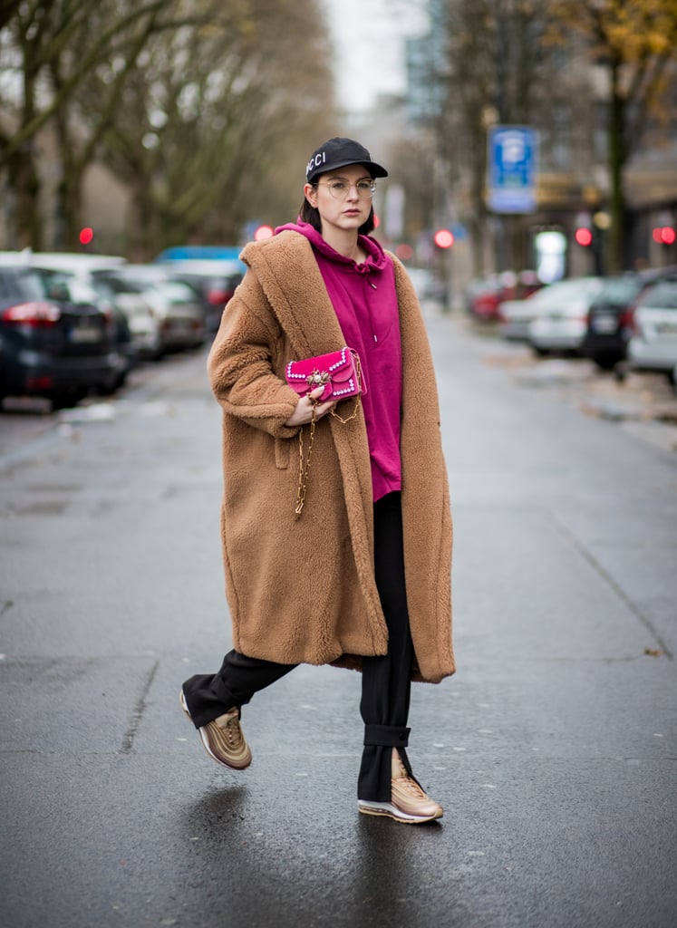 With a Cap, a Long Coat, a Hoodie, and Black Trousers