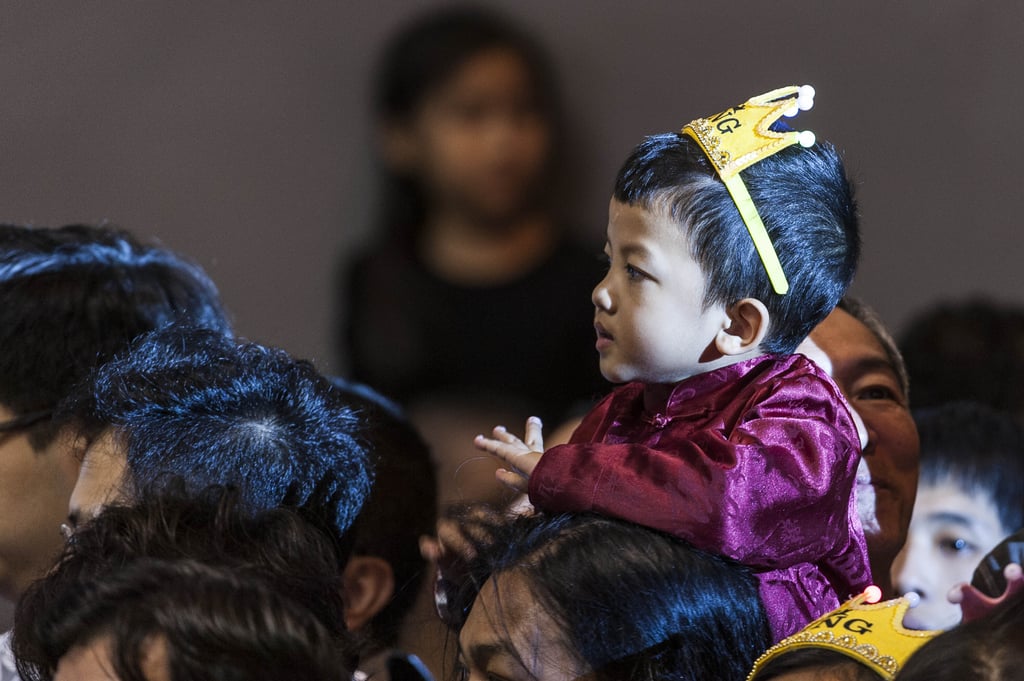 A little one watched the Chinese New Year nighttime parade in Hong Kong.