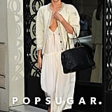 Later, Miranda kept the same dress on but changed up her outerwear to a sophisticated tweed jacket and switched her gray bag to a black quilted Chanel.