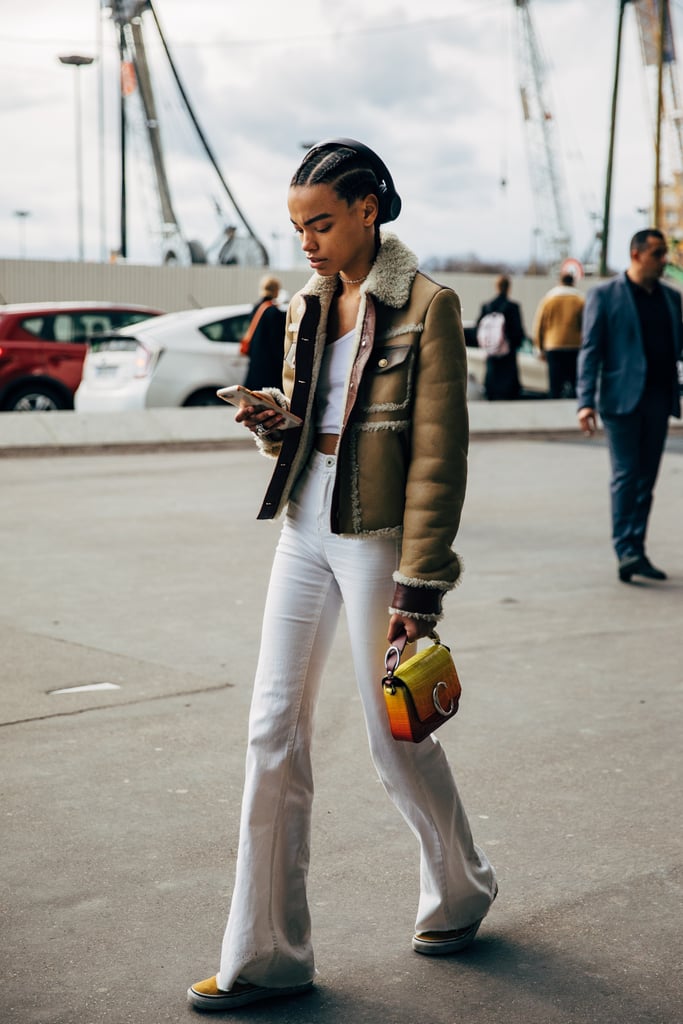 With a White Crop Top, Suede Aviator Jacket, and Colorful Sneakers