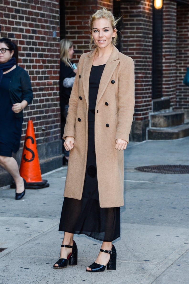 She Knows She'll Look Just as Spiffy When She Covers Her LBD With a Camel Coat