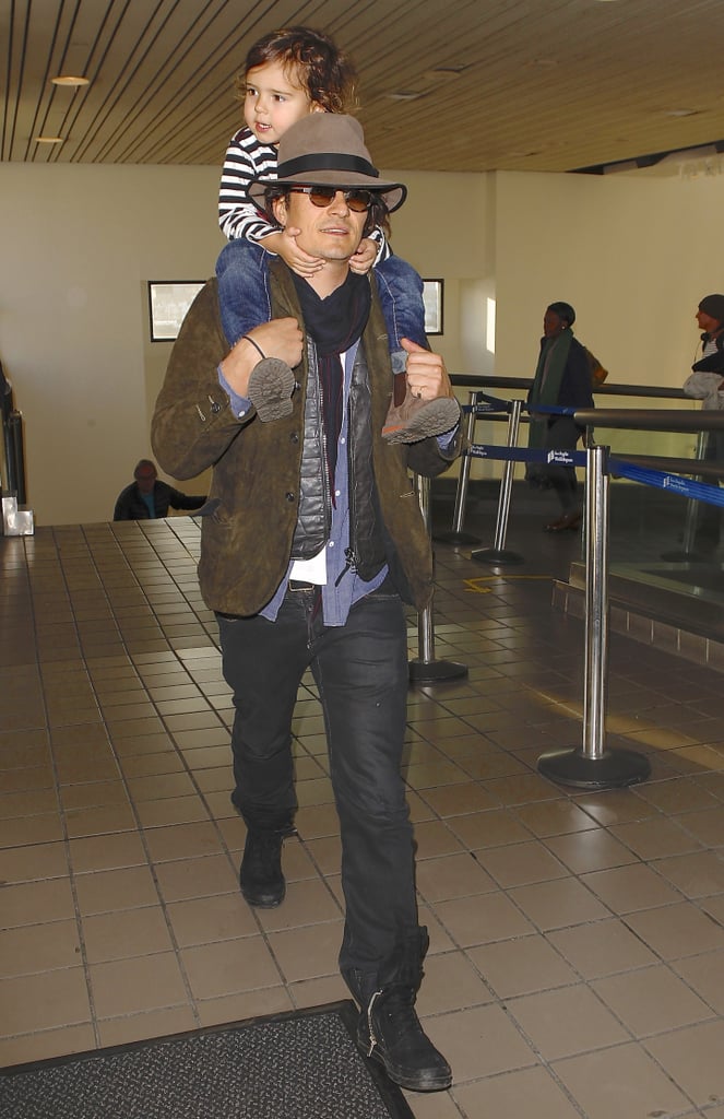 Orlando Bloom carried Flynn on his shoulders when he landed in LA on Thursday.