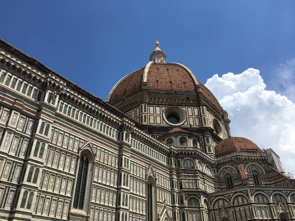 Our first day in Florence began with a trip to Piazza del Duomo, a square in the heart of Florence that houses the medieval Cathedral of Santa Maria del Fiore (once the largest church in Europe), Brunelleschi's Dome, Giotto's Bell Tower, a baptistry, and a museum. Admission to the cathedral is free, but you'll need a €15 ticket to explore the other sites on the piazza. This will also give you the opportunity to choose a time to climb the dome and bell tower so you aren't stuck waiting in yet another long line. 

At 463 steps, it's a long climb to the top of the dome, but your hard work will be rewarded with views of Florence and the surrounding hills of the Tuscany region. The bell tower has almost as many steps and similar views, and the baptistry allows you to rest your legs and admire the mosaics until you are ready for more walking. The museum is a wealth of medieval, Renaissance, and Baroque masterpieces that took up a surprising part of the afternoon to explore.
  
Be sure to check opening and closing times for each building before you go — we thought we knew the schedule, but there was a different one posted on the doors of the baptistry when we arrived, so we had to rearrange our plans a bit in order to see everything.