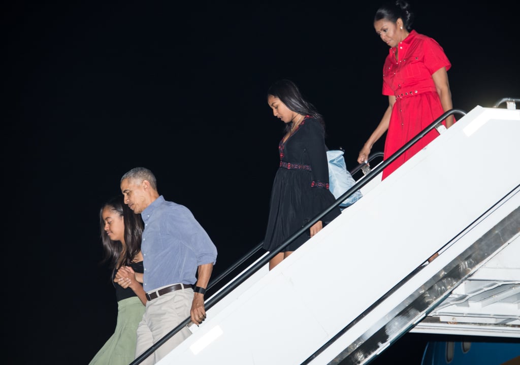 Michelle wearing a red shirtdress on her way to Hawaii.
