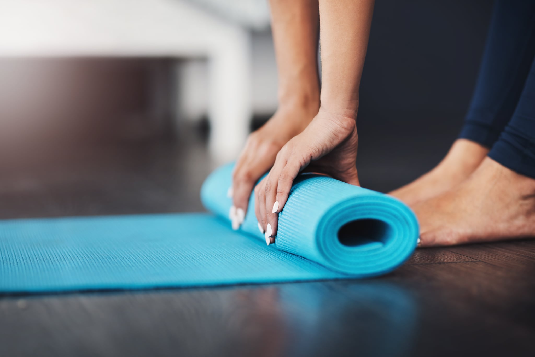 Cropped shot of an unrecognizable young woman rolling up her yoga mat in her bedroom