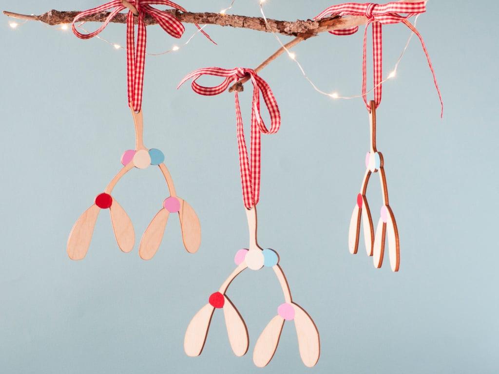 Unlike real mistletoe, the old standby, shoppers can rehang these sleek and contemporary Hand-Painted Wooden Mistletoe Tree Ornaments ($10) year after year for hundreds of kisses to come.