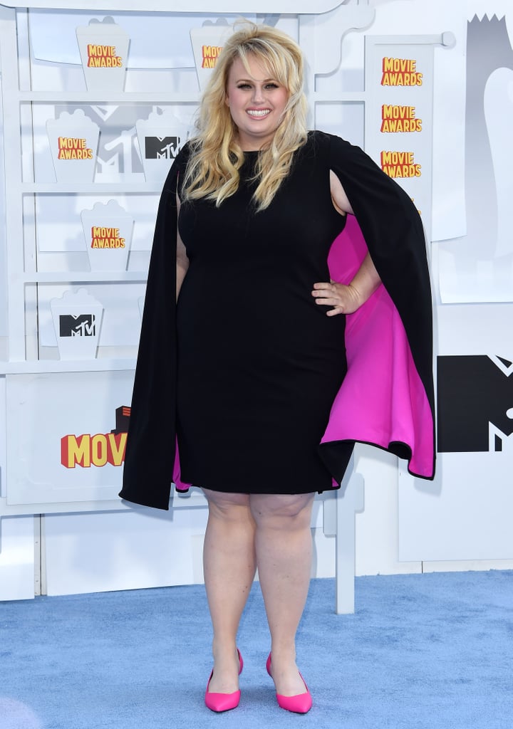 We oohed and ahhed over this cool caped dress at the MTV Movie Awards. The only outfit that topped it that night? The one that Rebel changed into when she got on stage: a bedazzled bra, leather leggings, and a pair of angel wings.